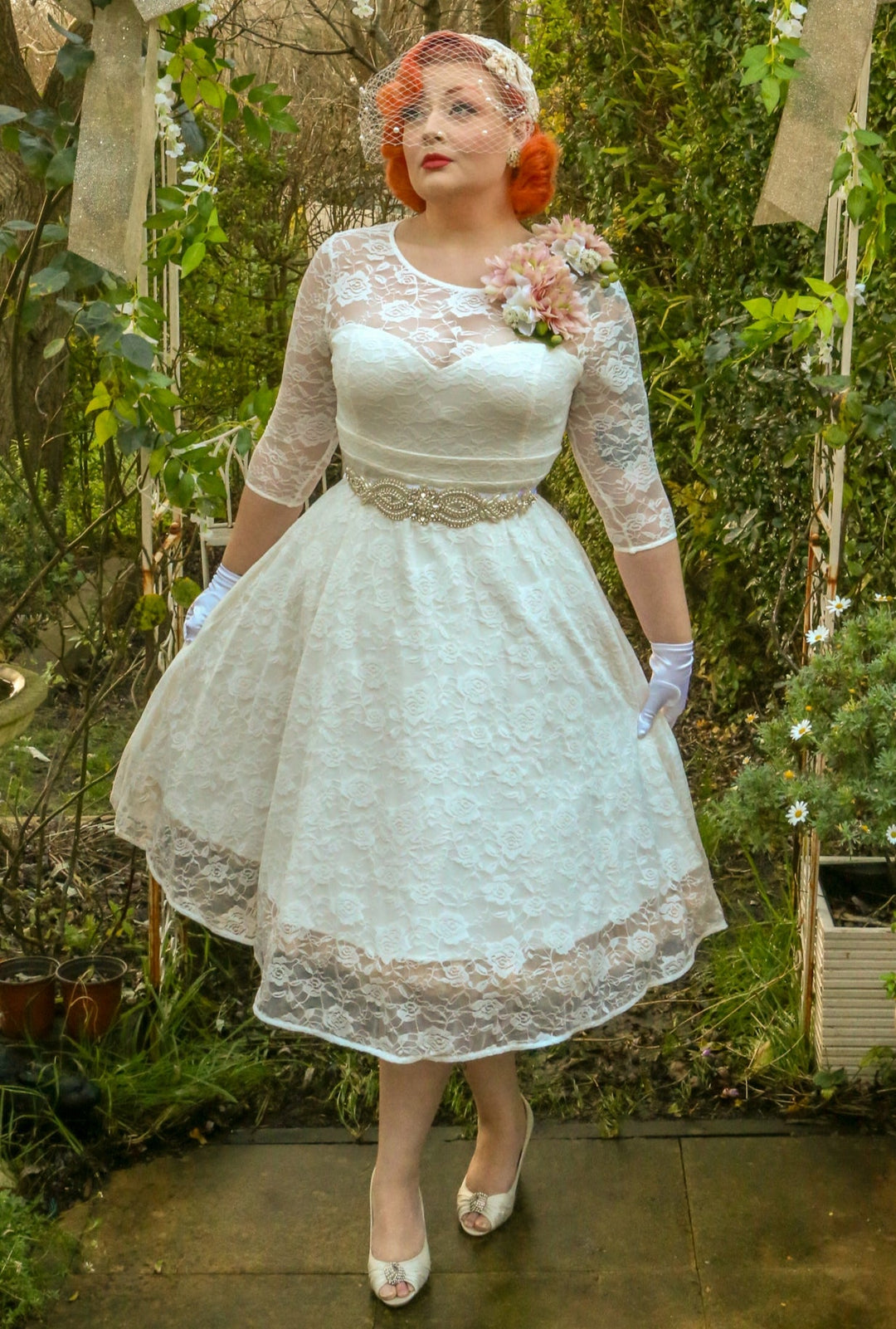 A Model wearing a Madeline Ivory White Dress