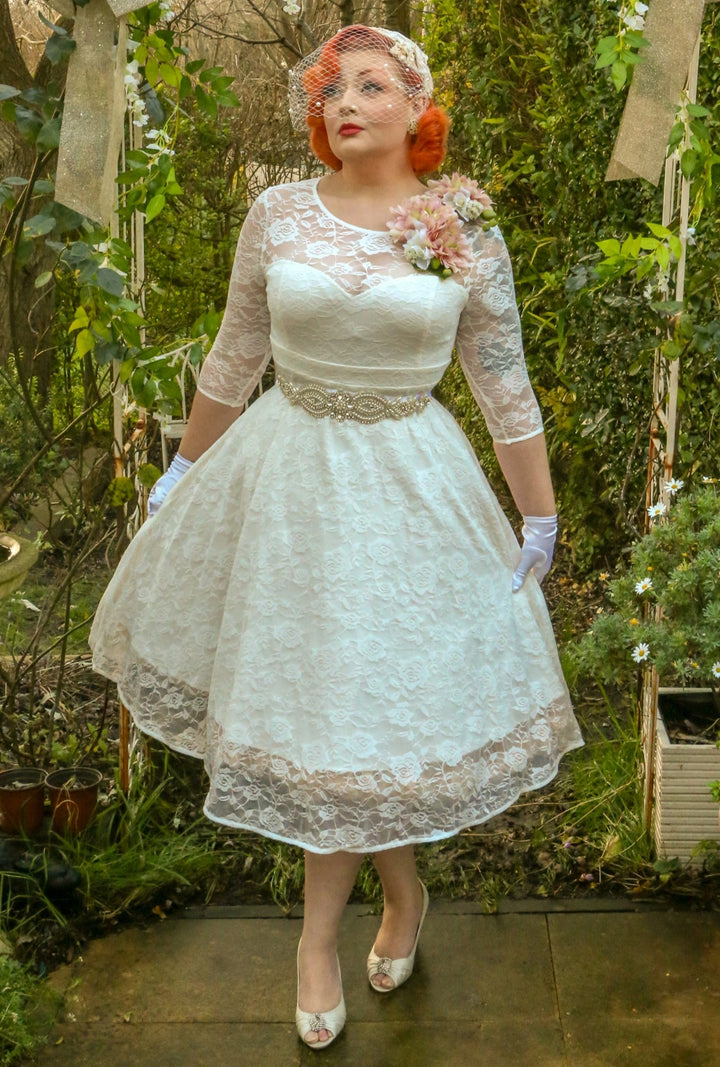 A Model wearing a Madeline Ivory White Dress