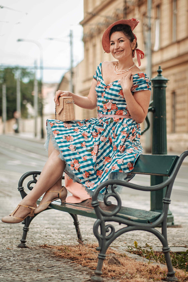 A charming lady wearing a Lily Floral Gingham Off Shoulder Dress In Blue