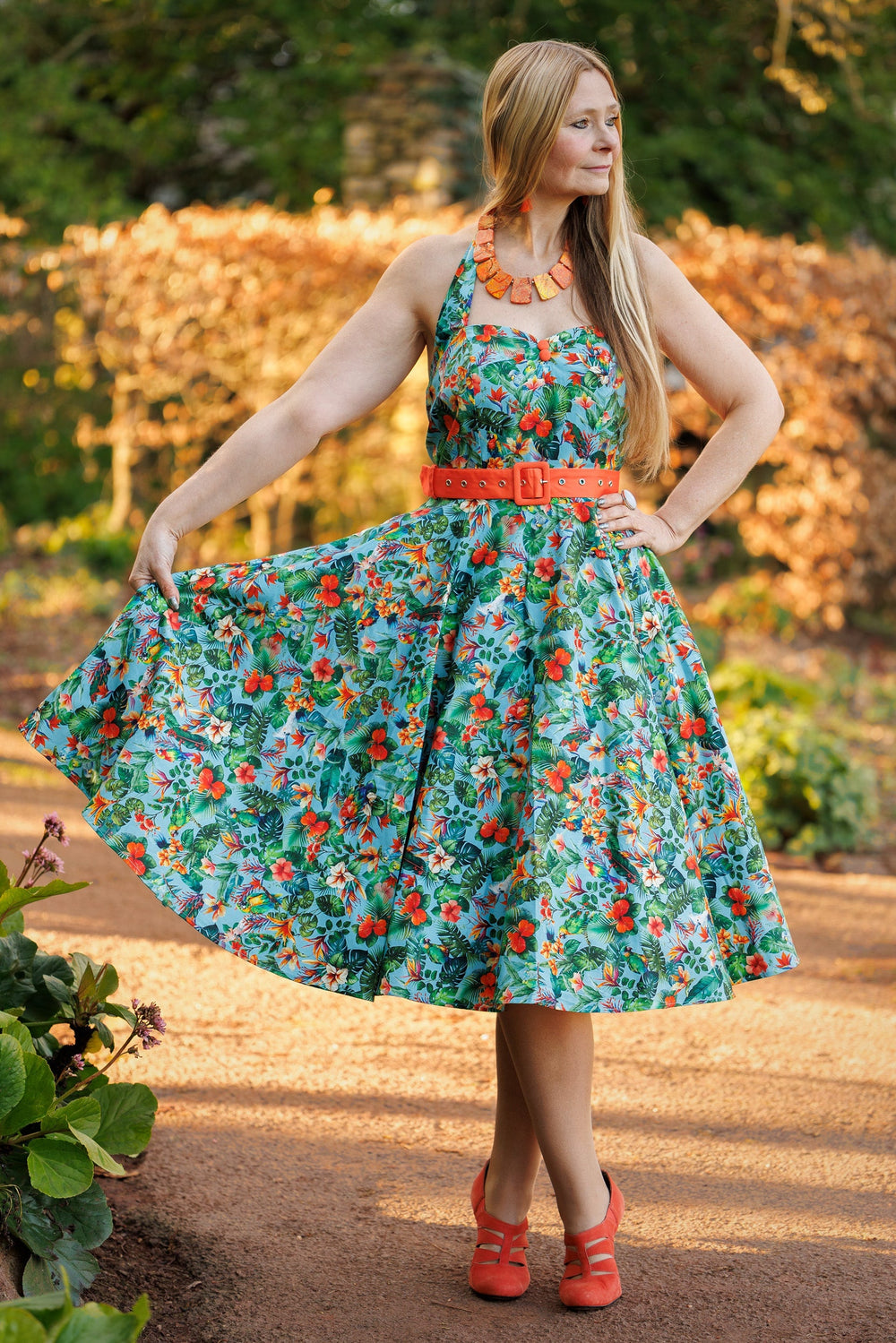 A model wearing a Daisy Tropical Parrot Halterneck Dress