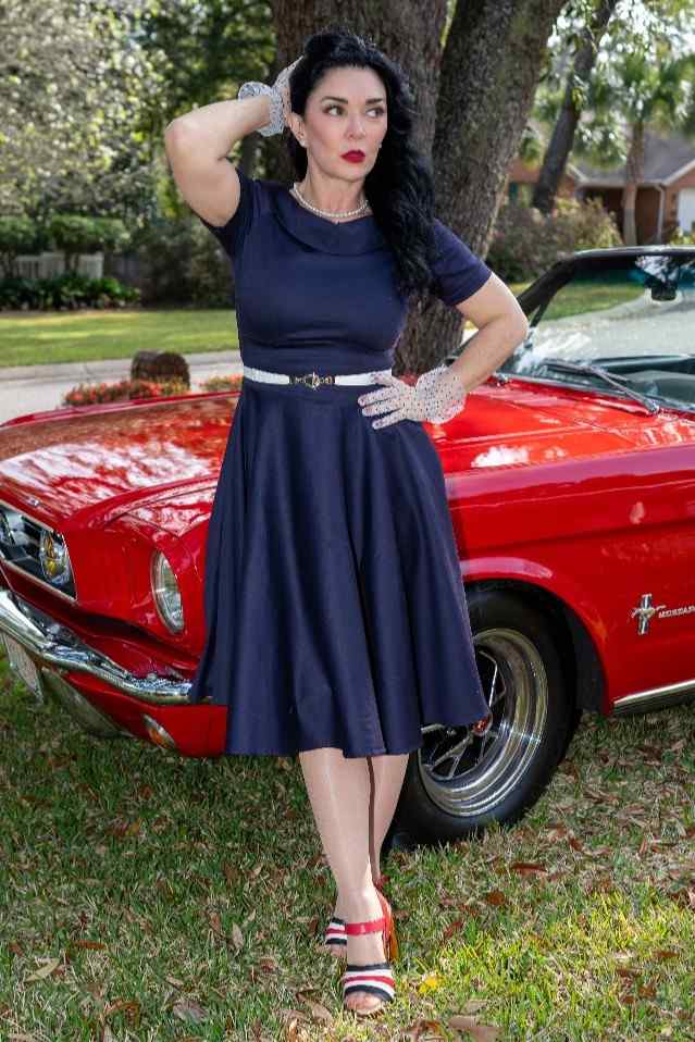 Lady wearing a Darlene Navy Roll Collar Dress