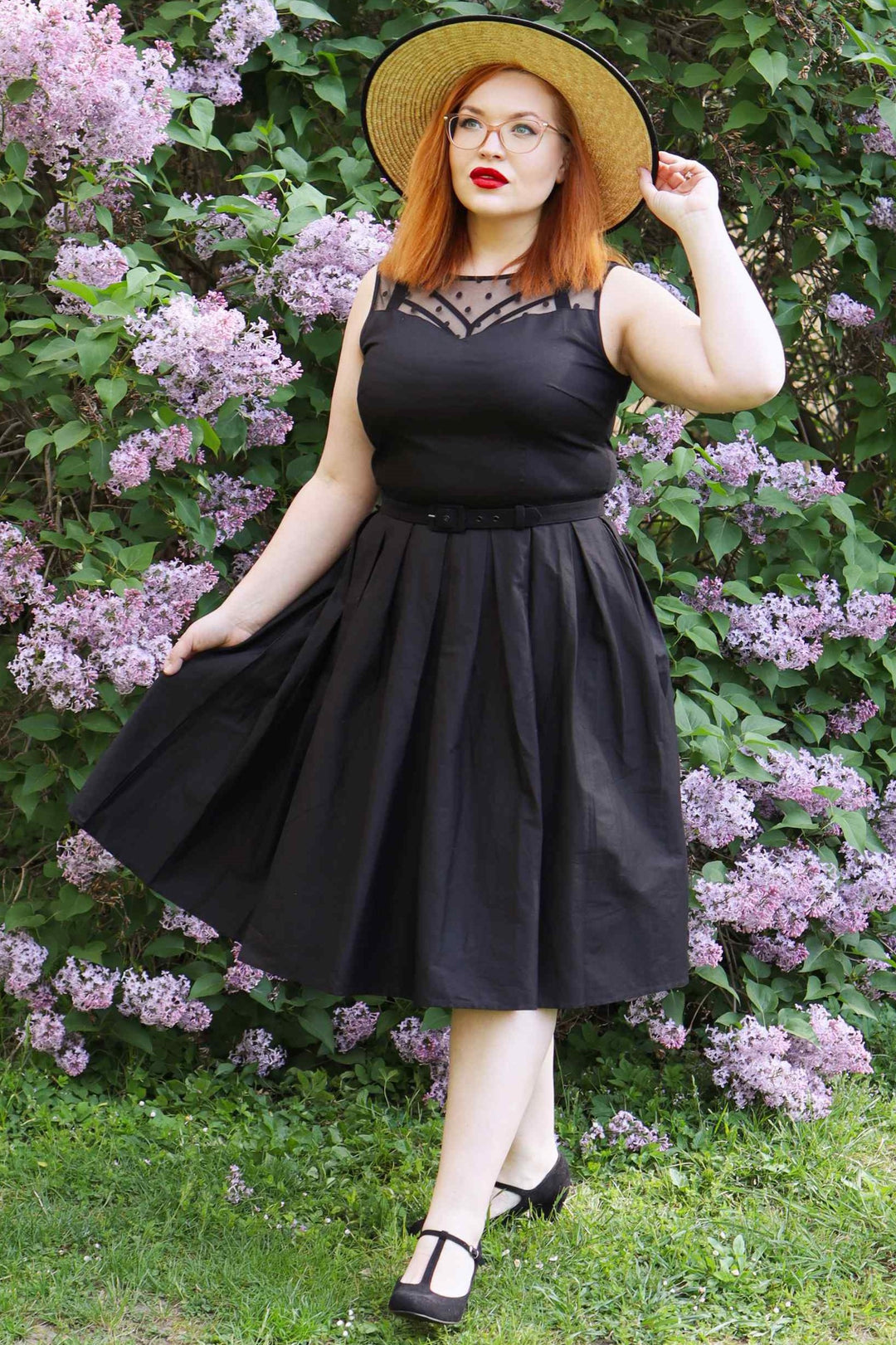 Lady wearing an Elizabeth Black Occasion Dress with Mesh Neckline posing.