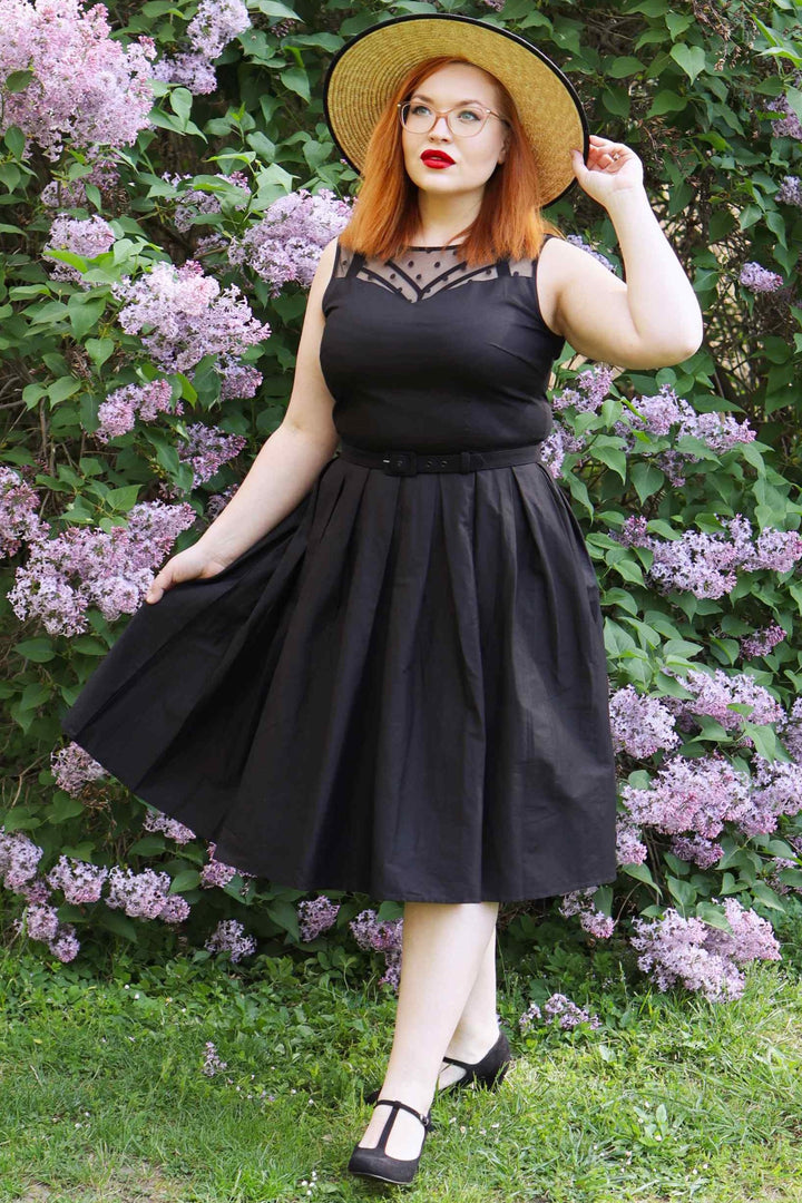 Lady wearing an Elizabeth Black Occasion Dress with Mesh Neckline posing.