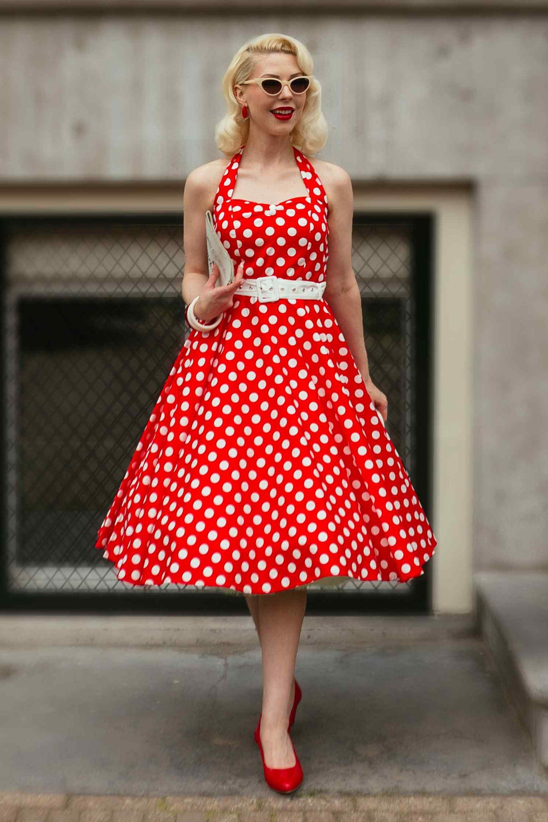 Model in a Daisy Red Polka Dot Halterneck Dress