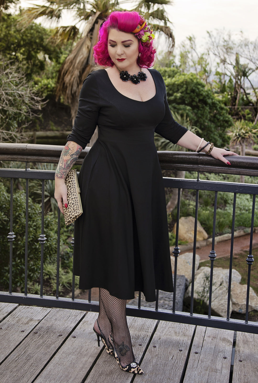 Model posing in Scarlette Black Long Sleeve Midi Dress