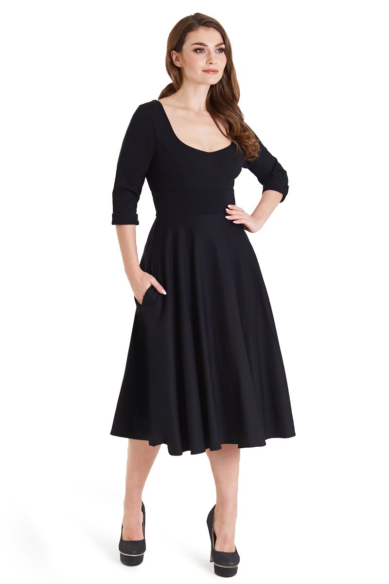 Model posing in Scarlette Black Long Sleeve Midi Dress in a studio