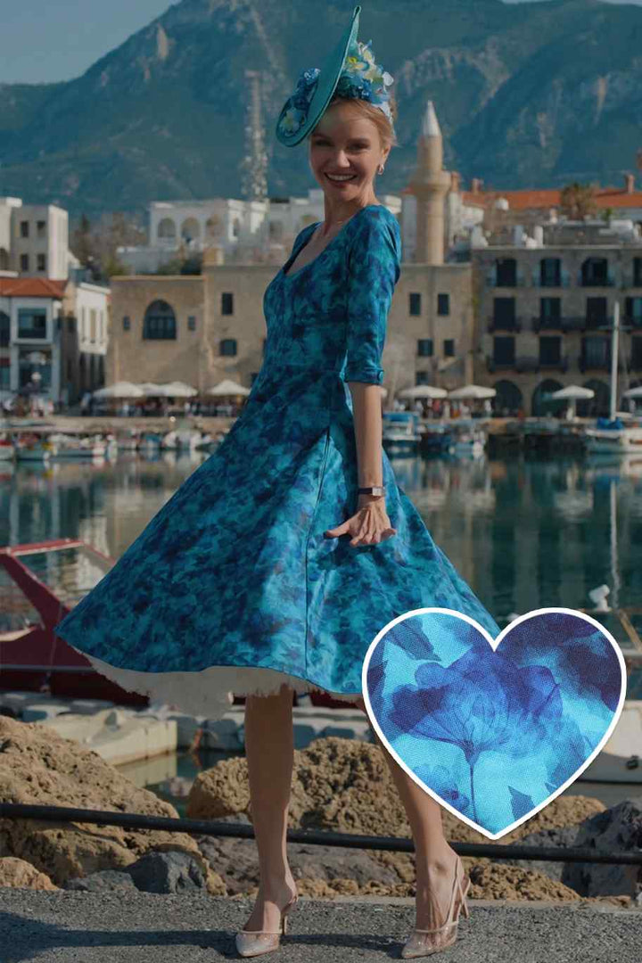 Model posing in Scarlette Blue Watercolour Floral Midi Dress