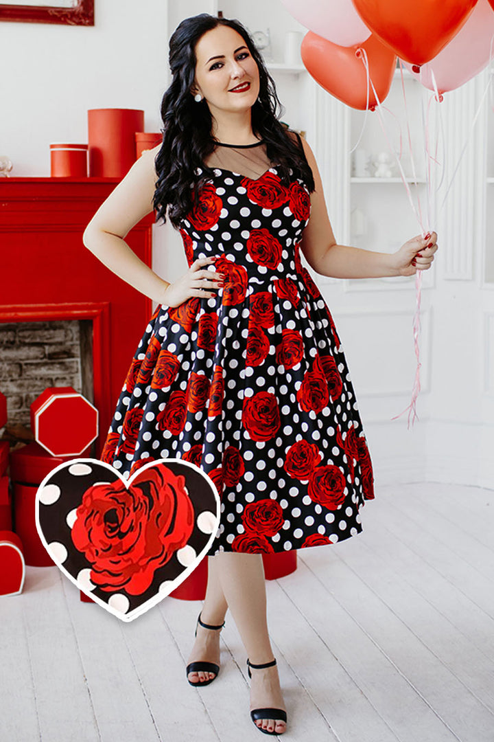 Model wearing An Elizabeth Occasion Dress in Black & Red Polka Rose Print