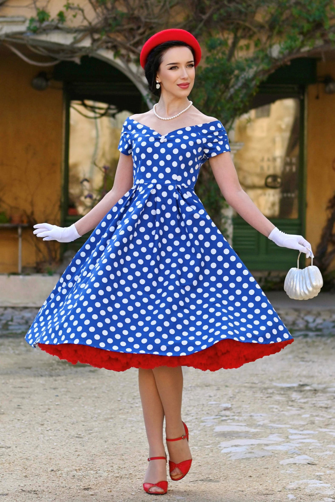 Model wearing a Lily Navy Blue & White Polka Dot Dress | 50s Style Dress
