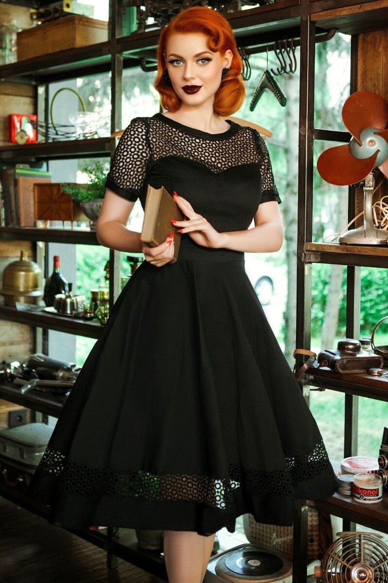 Model wearing a Tess Crochet Lace Formal Dress In A Cafe