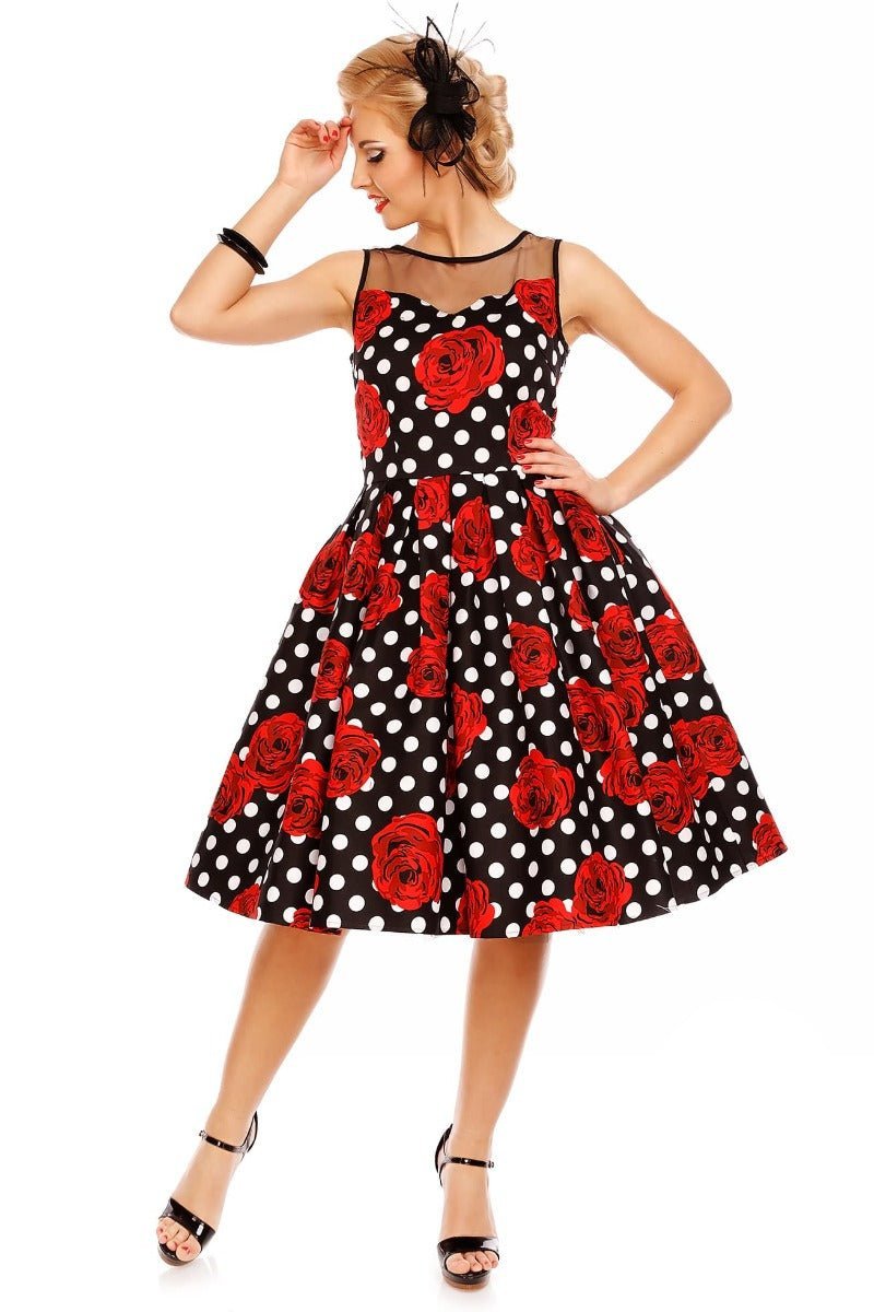 Model wears An Elizabeth Occasion Dress in Black & Red Polka Rose Print in a studio