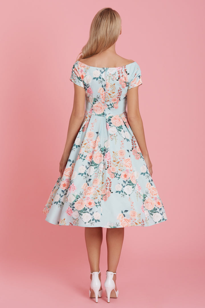 The back of Lady wearing a Lily Bardot Midi Dress in Mint Floral Print in a studio