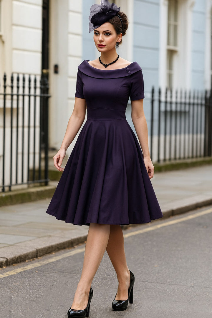 The model wearing a Darlene Navy Roll Collar Dress
