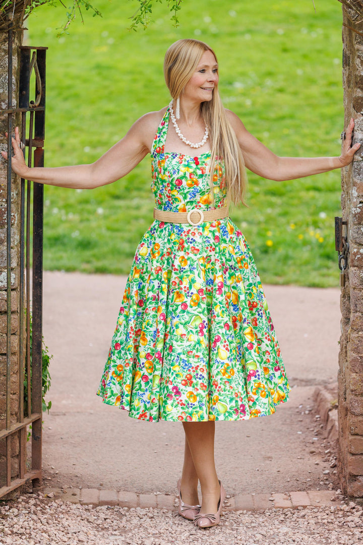 A beautiful lady in Daisy Mediterranean Fruit Halter Dress | Vintage Halter Dress