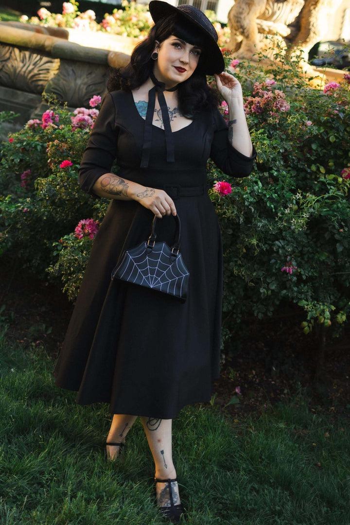An elegant lady in our Black Long Sleeve Midi Dress | LBD