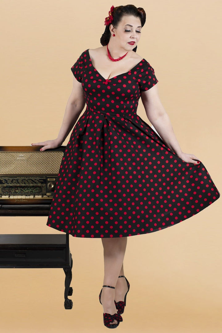 A beautiful model in our Lily Red Polka Dot Off Shoulder Dress In Black