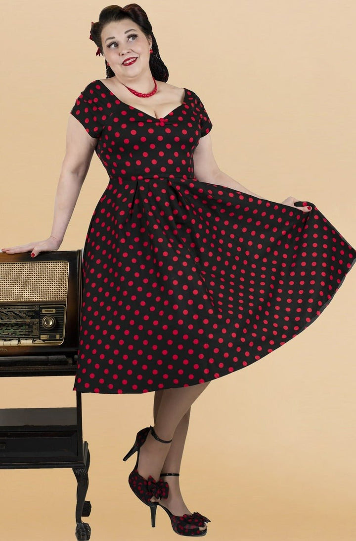 An elegant model wearing our Lily Red Polka Dot Off Shoulder Dress In Black