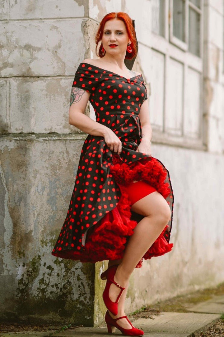 A lovely model in our Lily Red Polka Dot Off Shoulder Dress In Black