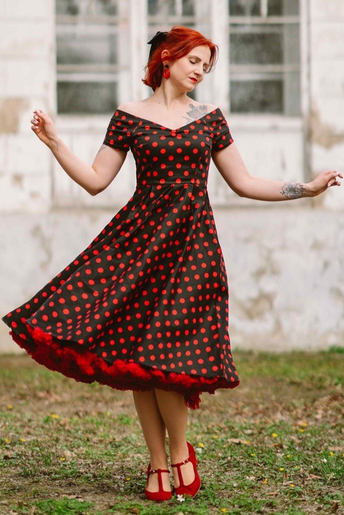 A model wearing Lily Red Polka Dot Off Shoulder Dress In Black