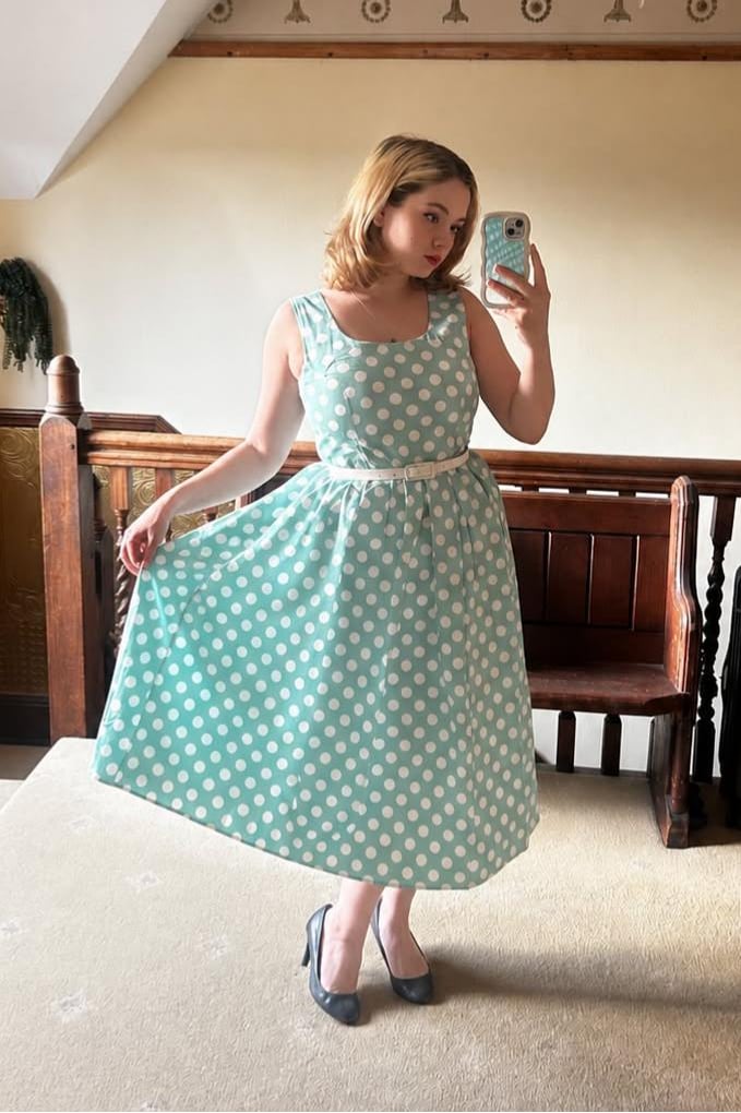 A beautiful lady in our Ophelia Sage Polka Dot Midi Dress