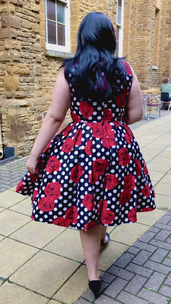 Video of lady wearing an Elizabeth Occasion Dress in Black & Red Polka Rose Print